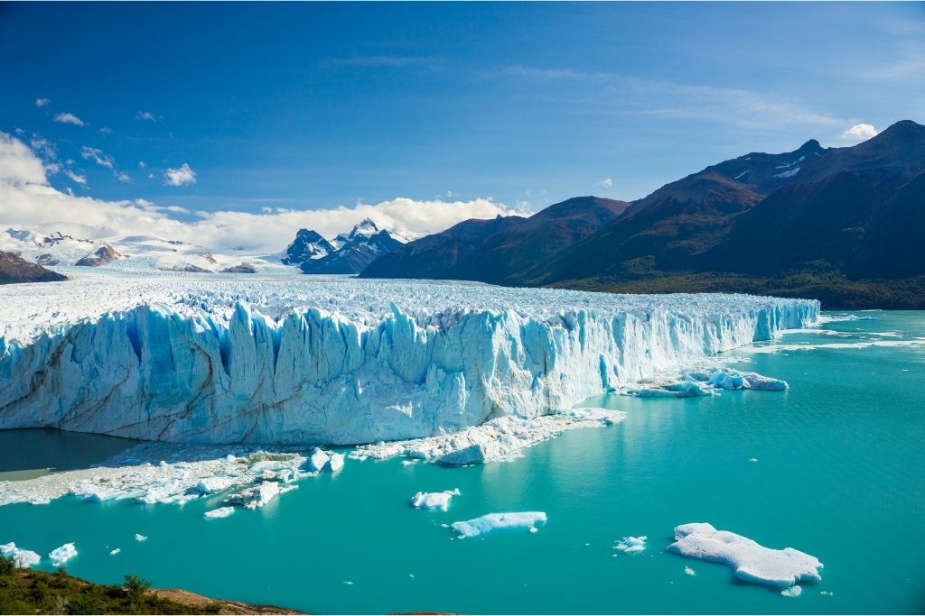 The impressive Perito Moreno Glacier and the turquoise blue waters it leads to, in Argentinian Patagonia.