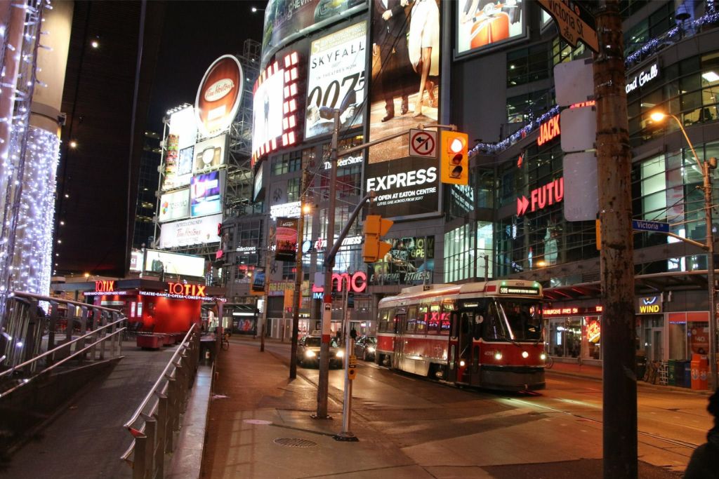 Why visit Toronto? Yonge Dundas Square outside the Eaton Centre in Toronto at night.