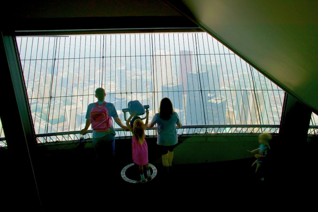 Why visit Toronto? A family looking down at the view from the top of the CN Tower.