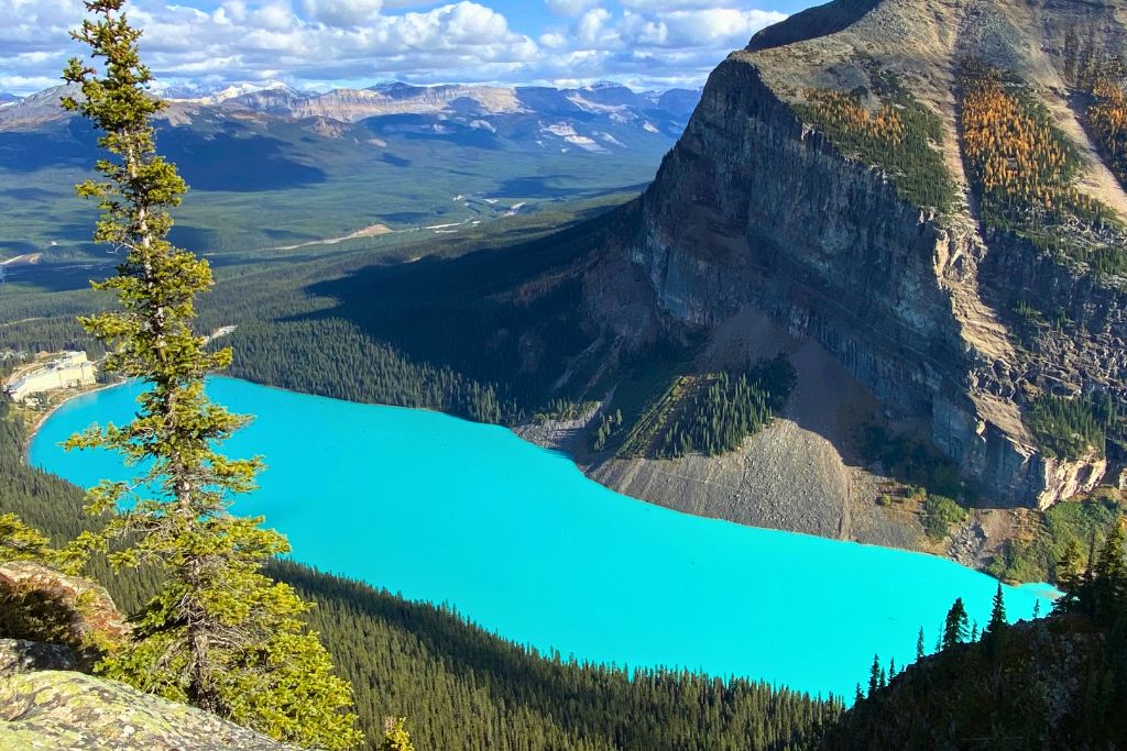 Bright blue Lake Louise in Alberta, Canada on a sunny day in early Fall.