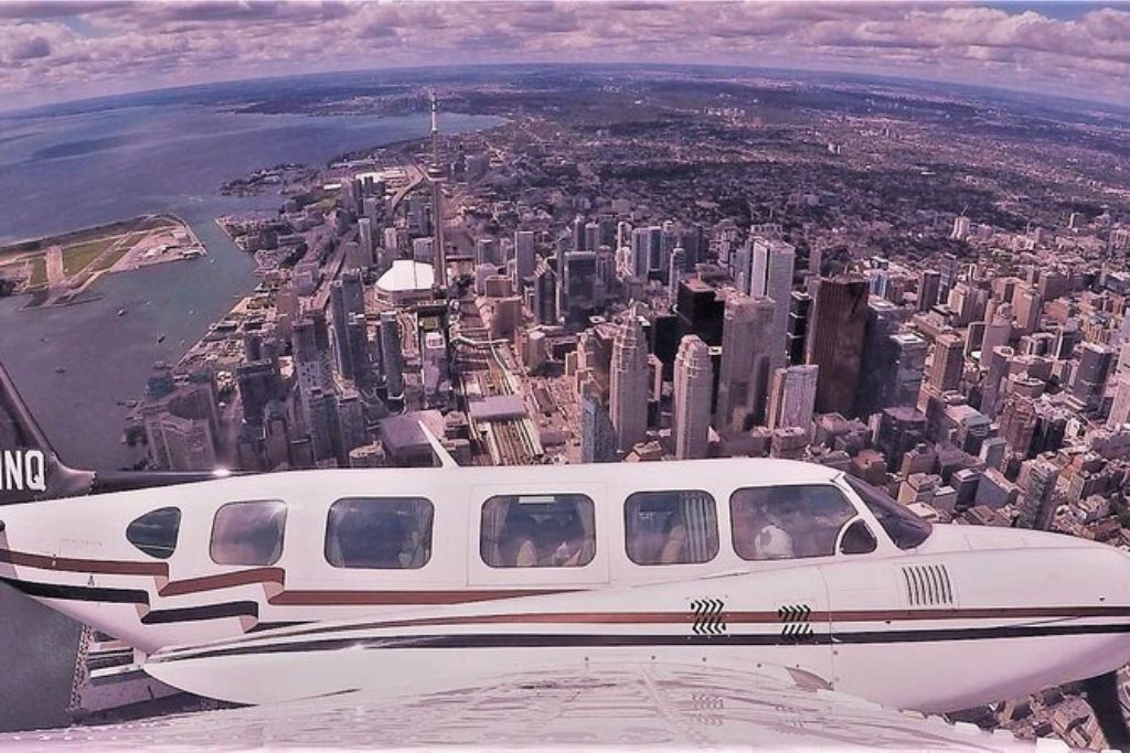 The small plane flying over Toronto on the Exhilarating 120km Aerial Tour of Toronto with iflyTOTO.