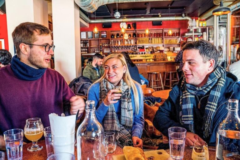 Three travellers enjoying a drink on the Montreal walking food tour with Secret Food Tours through Viator, which is the top Montreal food tour.