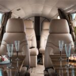 The interior of the plane set up with a bottle of champagne and snacks on the One hour Aerial Tour of Toronto and Niagara Falls with iflyTOTO.