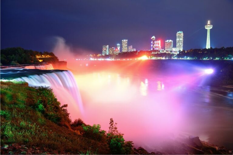 Why visit Niagara Falls? The view of the falls illuminated at night.